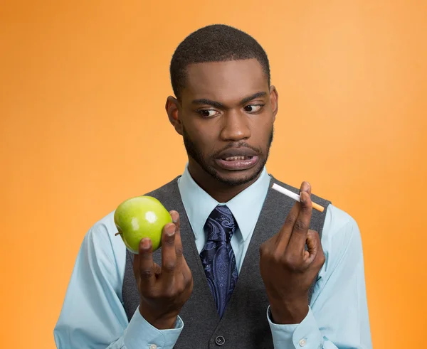 Man craving cigarette versus green apple