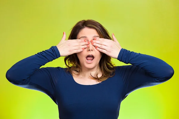 Woman closing eyes with hands can\'t see. See no evil concept