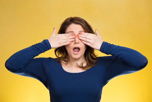 Woman closing eyes with hands can\'t see. See no evil concept