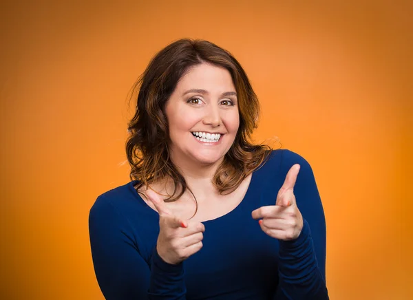 Happy woman pointing fingers at you camera gesture