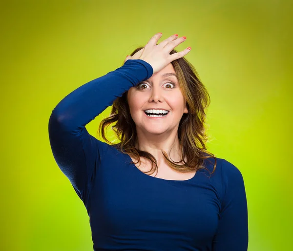 Woman placing hand on head, palm on face gesture in duh moment