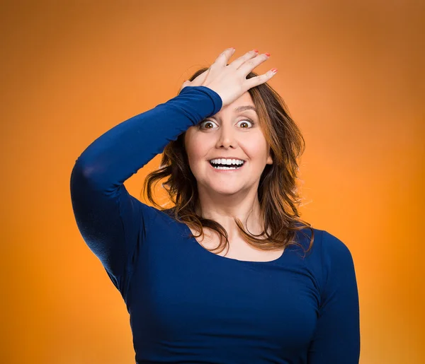 Woman placing hand on head, palm on face gesture in duh moment