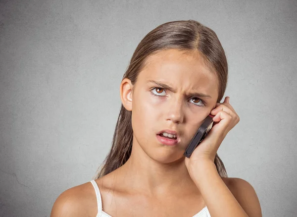Angry teenager talking on cell phone