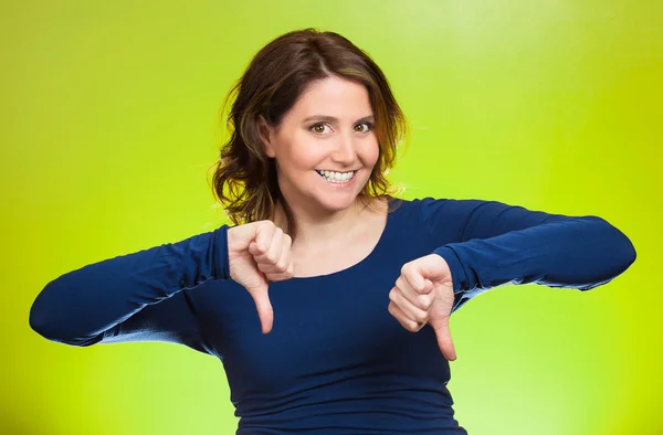 Woman showing thumbs down hand gesture, happy someone made mistake