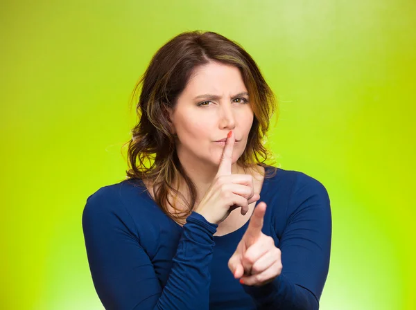 Woman placing finger, hand on lips, shhh gesture, be quiet