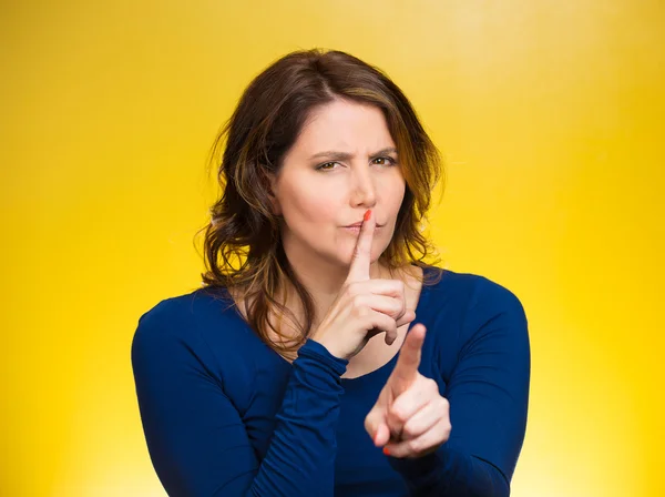 Woman placing finger, hand on lips, shhh gesture, be quiet