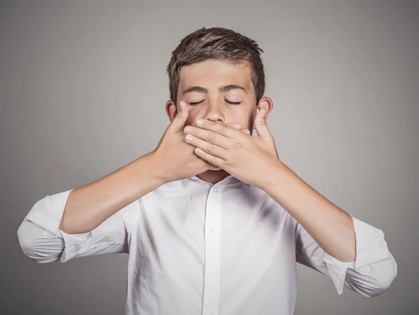 Student, boy, covering his mouth with hands. Speak no evil concept