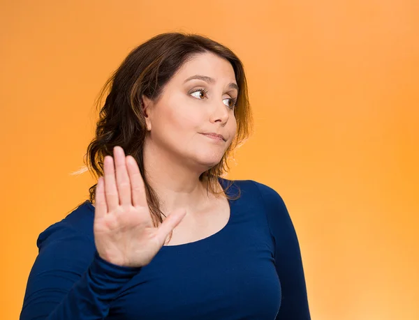 Grumpy woman with bad attitude, giving talk to my hand gesture