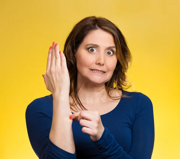 Woman pinching her arm skin, giving reality check gesture