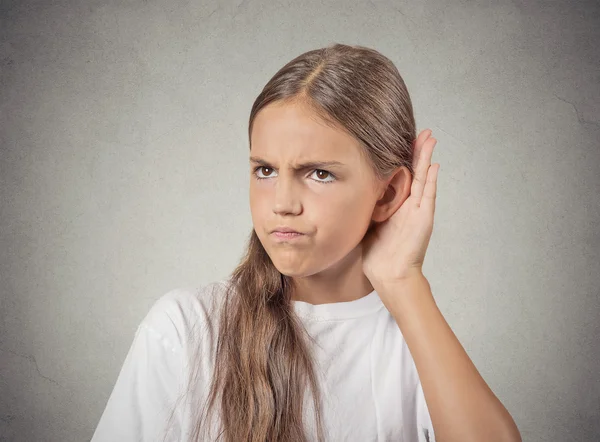 Curious teenager girl  hand to ear, listening to gossip