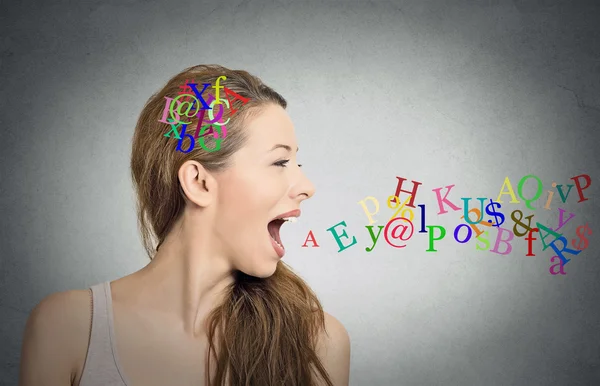 Woman talking, alphabet letters in her head and coming out of mouth