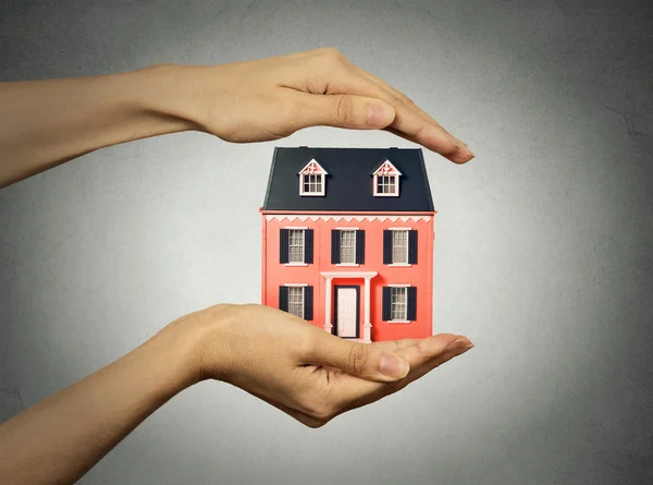 Woman hands presenting small model of house