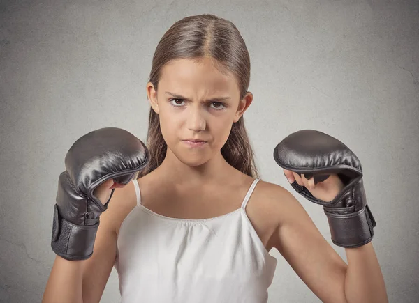 Aggressive child teenager girl wearing boxing gloves