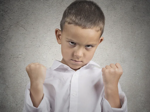 Angry child, boy with fist up in air, pissed off