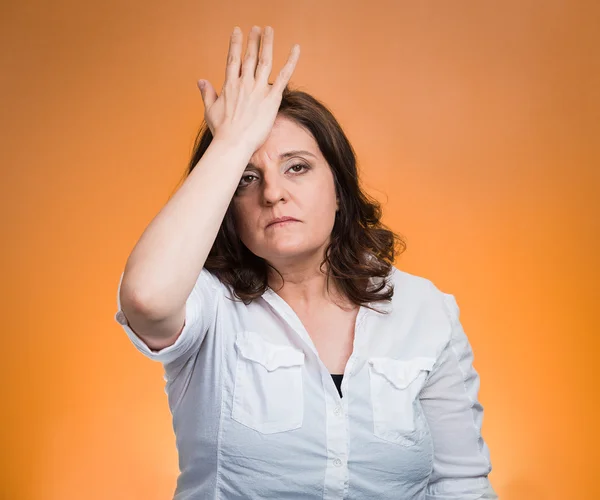 Woman with palm on face gesture in duh moment