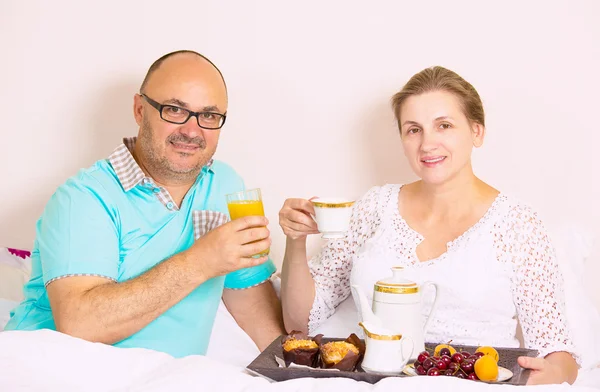 Couple having breakfast in bed