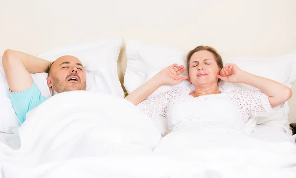 Snoring man, frustrated woman
