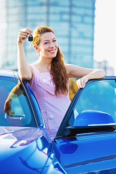 Woman showing keys of new car