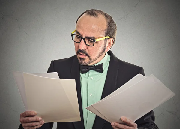 Confused businessman looking at documents