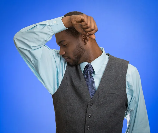 Man smelling sniffing his armpit