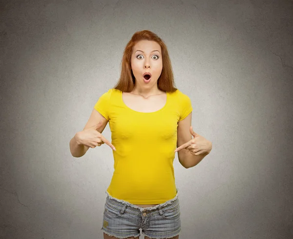 Woman pointing at blank copy space of her yellow t-shirt