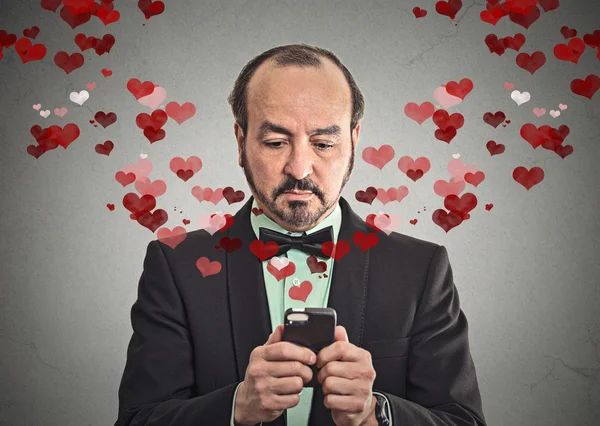 Man sending love sms with mobile phone