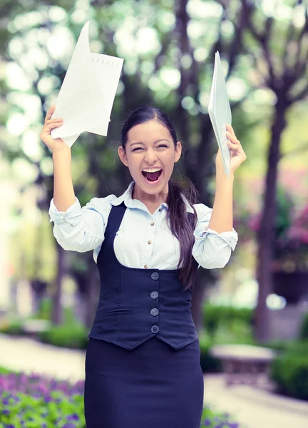 Successful business woman with arms up celebrating.