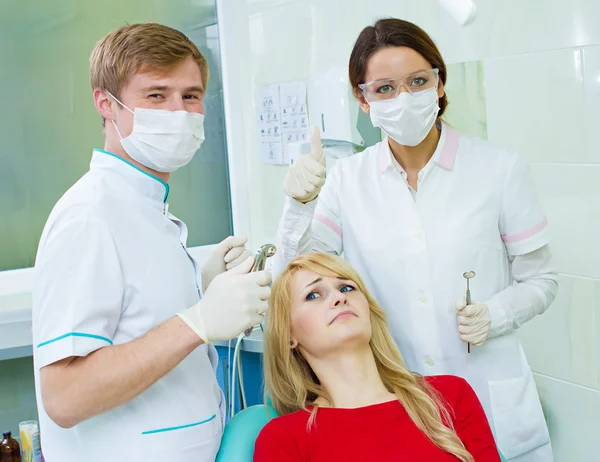 Worried patient and confident dentist in clinic office