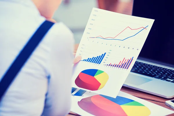 Woman hands with financial charts papers