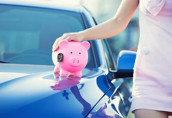 Woman customer, agent and new car, pink piggy bank key on hood