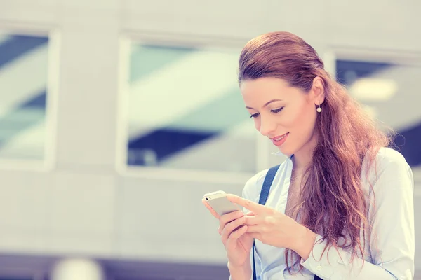 Happy, cheerful, girl, excited by what she sees on cell phone