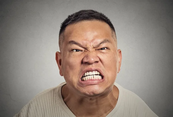 Headshot angry middle aged man with open mouth aggressive screaming