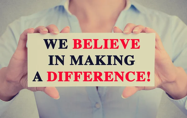 Businesswoman hands sign with We Believe in Making a Difference message