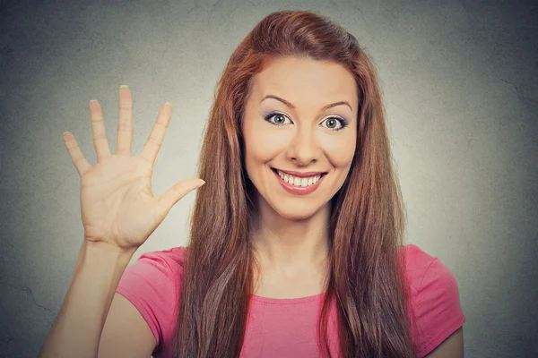 Woman showing five times sign gesture with hand