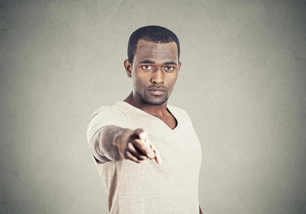 Closeup portrait man pointing finger isolated grey background.