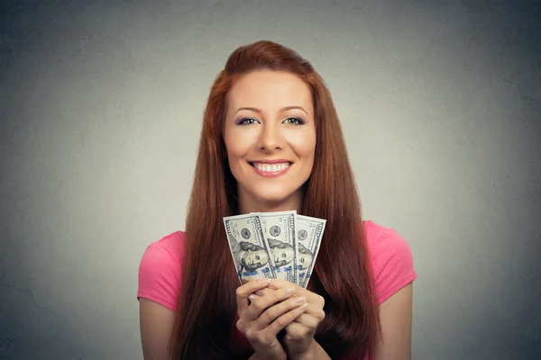 Happy excited successful young business woman holding money dollar bills