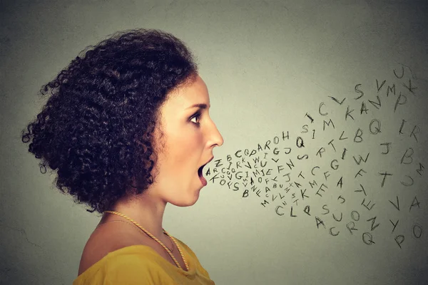 Woman talking with alphabet letters coming out of her mouth. Communication intelligence concept