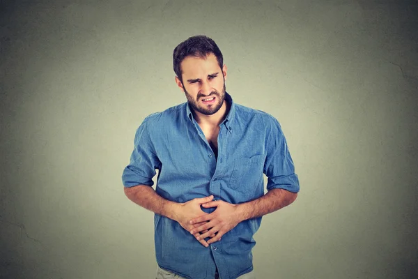 Young man with stomach pain indigestion