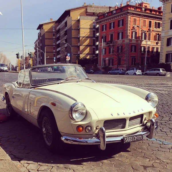 Old Triumph car in street