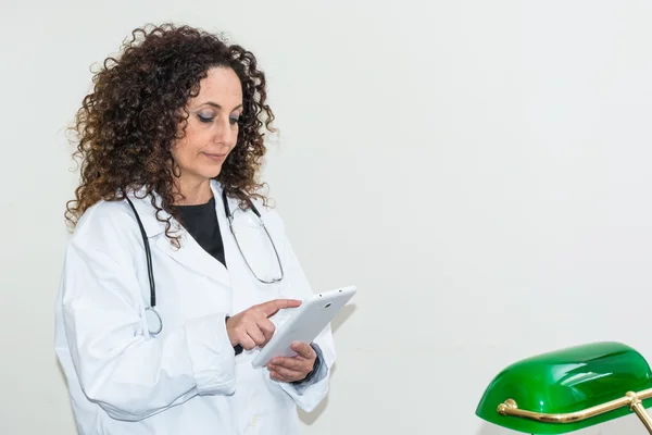 Doctor with curly hair and blacks and with green eyes, use a tab