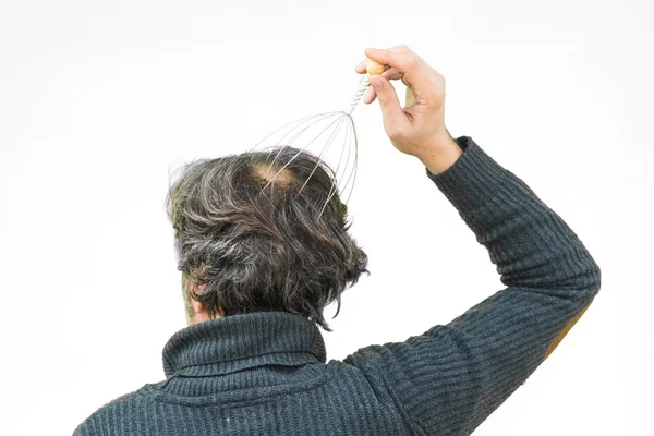 Man relaxes with the Genie head massager. Alternative Therapy.