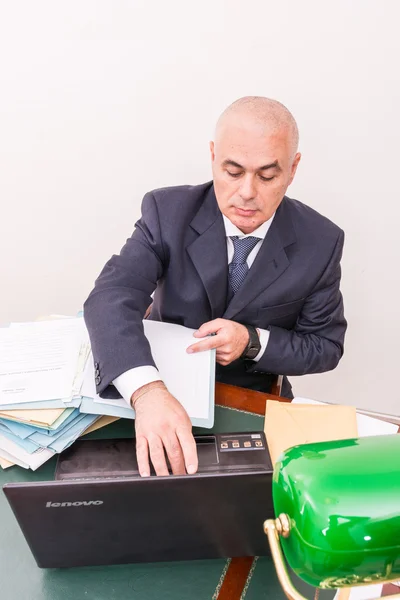 Business man with your files and paperwork on desk, in office.
