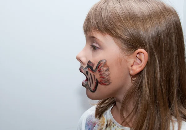 Girl with painted face side view