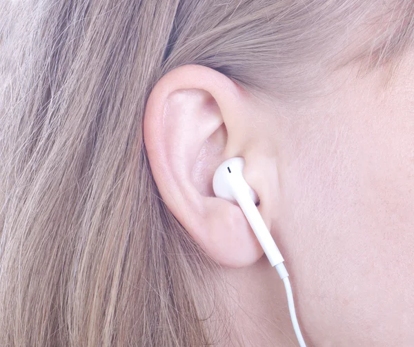 Woman`s ear and headphones