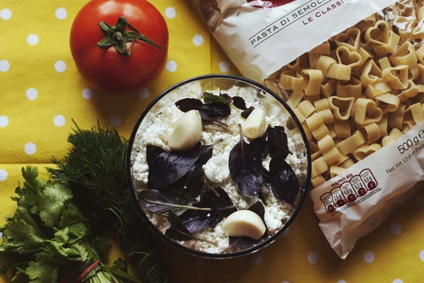 Cottage cheese, tomato and packaging of pasta