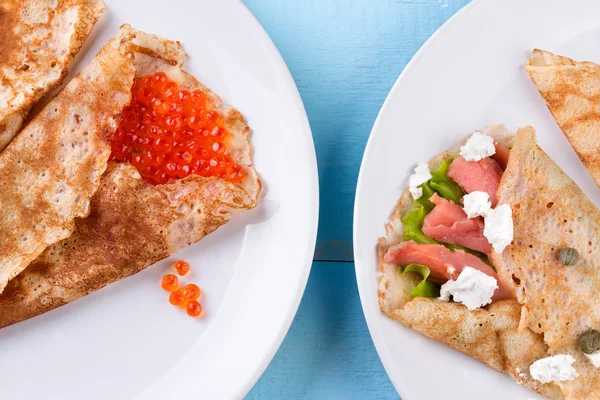 Thin pancakes, crepes with red caviar and salmon