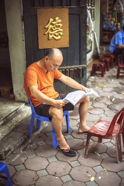 HANOI, VIETNAM - APRIL 8, 2015: Unidentified vietnamese man read