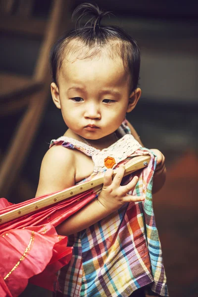 HOI AN, VIETNAM, JUNE 15: A little girl playing with an fan, on