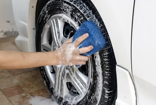 Man hand hold Sponge wash a car