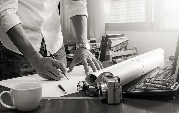 Black and white pic of man working  at office